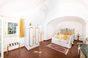 a living room with a white couch and yellow pillows at La Casa di Peppe in Positano +92 photos