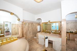 a bathroom with two sinks and a tub and a mirror at La Casa di Peppe in Positano +81 photos
