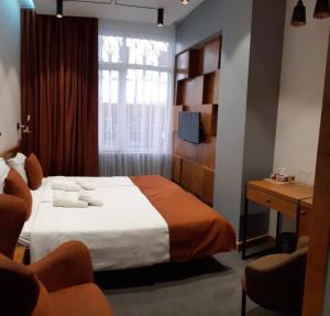 Postel nebo postele na pokoji v ubytování R&R Hotel