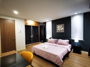 um quarto com uma cama grande e almofadas cor-de-rosa em Batu Ferringhi Gold Pearl Luxury Homestay Near Beach With Intex Pool em Batu Ferringhi