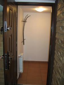 a door leading to a bathroom with a shower at Noclegi u Marcela in Ustrzyki Dolne