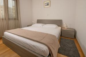 Postel nebo postele na pokoji v ubytování Apartments Oliva