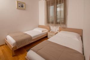 Postel nebo postele na pokoji v ubytování Apartments Oliva