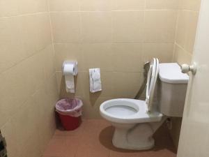 a bathroom with a toilet and a trash can at Pro Chill Krabi Guesthouse in Krabi town