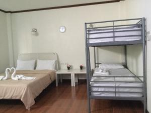 a bedroom with two bunk beds and a table at Pro Chill Krabi Guesthouse in Krabi