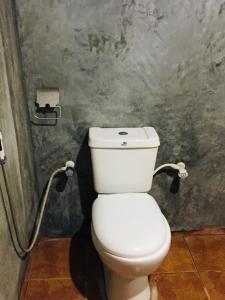 a bathroom with a white toilet in a room at Tree house Hostel Sigiriya in Sigiriya