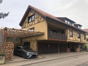 a car parked in front of a house at Business-Apartment Braun in Abstatt