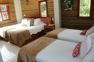 Postel nebo postele na pokoji v ubytování HOTEL IGUAIMA