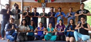 a group of people doing yoga in a room at Vista Hostel Jeolikote, Nainital in Patwa Dunga