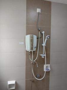 a shower in a bathroom with a shower head at Galina Somersquare Goldenhills Aprt Pasar Malam Cameron Highlands in Brinchang