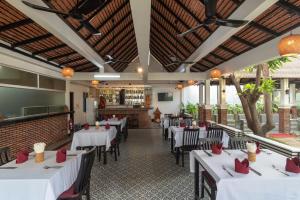 a restaurant with white tables and chairs and a bar at Lavender Angkor Boutique in Siem Reap