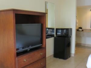 a flat screen tv in a wooden entertainment center at Flagship Inn in Lake Brownwood