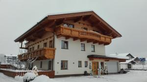 ein Haus mit einem Holzbalkon darüber in der Unterkunft Dorfjuwel Alpbachtal in Reith im Alpbachtal