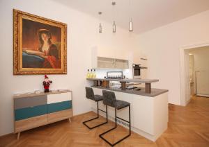 a kitchen with a painting on the wall and a counter at Luxusapartment Altes Rathhaus in Vienna