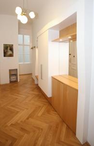 a kitchen with white walls and wooden floors at Luxusapartment Altes Rathhaus in Vienna