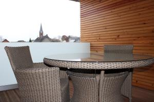 a table and chairs sitting on a balcony at Klein-Fein in Euskirchen