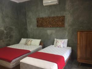 Ein Bett oder Betten in einem Zimmer der Unterkunft Watukarung Ristu Homestay