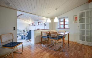 a kitchen and dining room with a table and chairs at 2 Bedroom Cozy Home In Eg in Skæring