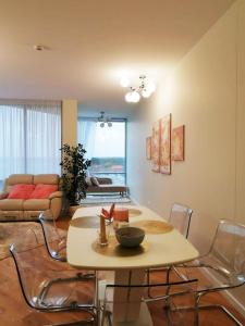 a living room with a table and chairs at Snieguolės apartamentai in Palanga
