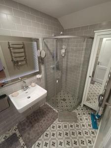 a bathroom with a shower and a sink at Snieguolės apartamentai in Palanga +36 photos