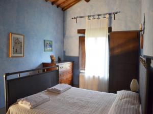 a bedroom with a bed and a dresser and a window at Borgo Santa Maria in Monteleone dʼOrvieto