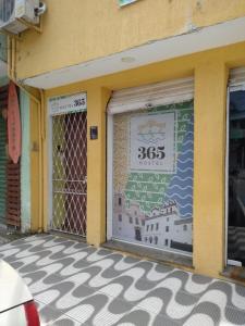 a store front door with a sign on it at Hostel365 in Angra dos Reis