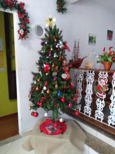a christmas tree in a room next to a staircase at Hostel365 in Angra dos Reis