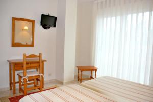 Łóżko lub łóżka w pokoju w obiekcie Hotel Casa Portuguesa