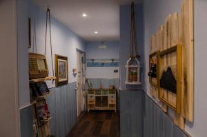 a hallway with blue walls and wooden floors at B&B Ammore in Castellammare di Stabia