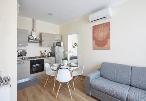 科莫的住宿－Beautiful bohemian apartment in center conditioned air，厨房以及带桌子和沙发的客厅。