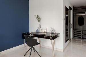a black desk with a chair in a room at Blue Arch - Luxury Serviced Apartment in Central Saigon in Ho Chi Minh City