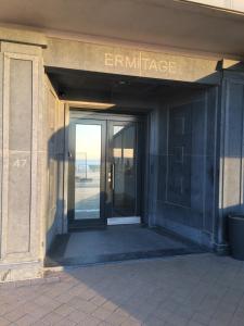 an entrance to a building with a glass door at appartement seafront in Ostend