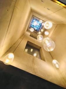 a ceiling with a chandelier and a window at S.Bento Residences in Porto