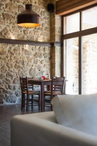 a dining room with a table and chairs and a window at Polys Guest House in Katachás