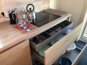 a kitchen counter with wine glasses and wine bottles at Amsterdam Twiskehouse in Den Ilp