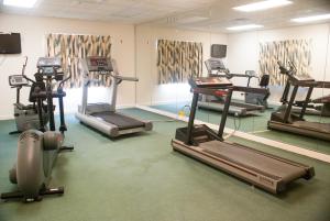 a gym with several tread machines in a room at Exploria Express by Exploria Resorts in Orlando