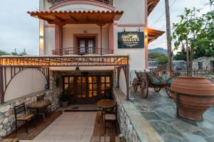 a restaurant with a horse drawn carriage outside of a building at MARIA'S BOUTIQUE Rooms in Korinthos