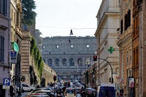 a busy city street with a large building in the background at Casa Santa Sofia in Rome