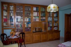 a room with wooden book shelves filled with books at Villa Giulia in Avezzano +27 photos