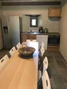 a kitchen with a wooden table with a basket on it at AU SOMMET DES NARCISSES in Albiez-Montrond