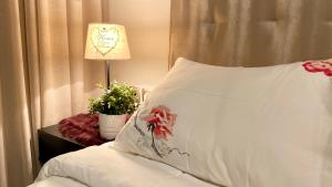 a bedroom with a bed with a pillow and a lamp at Best in Town - Central -Comfortable-in Racine in Casablanca