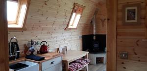 a kitchen with wooden walls and a wooden counter top at Panoramic Pods in Allendale Town