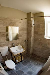 a bathroom with a sink and a toilet and a shower at Cloud 9 Living in Bucharest