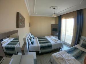 Postel nebo postele na pokoji v ubytování Bellamaritimo Hotel + 37 fotografií