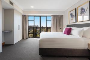 Uma cama ou camas num quarto em Avani Metropolis Auckland Residences