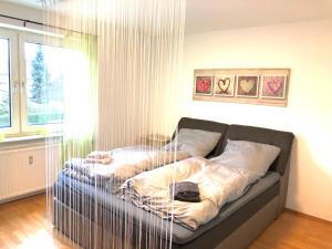 a bed sitting in a room with a window at Paradise Apartments in Dortmund