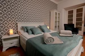 a bedroom with a large bed with blue pillows at Bloom apartments in Belgrade