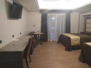 Postel nebo postele na pokoji v ubytování Hotel Jiménez Plaza