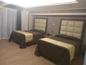 Postel nebo postele na pokoji v ubytování Hotel Jiménez Plaza