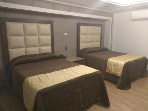 Postel nebo postele na pokoji v ubytování Hotel Jiménez Plaza
